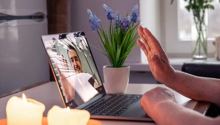 old-woman-communicates-with-her-son-via-video-link-through-laptop